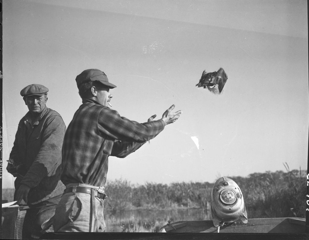 Miniature of Men releasing bird