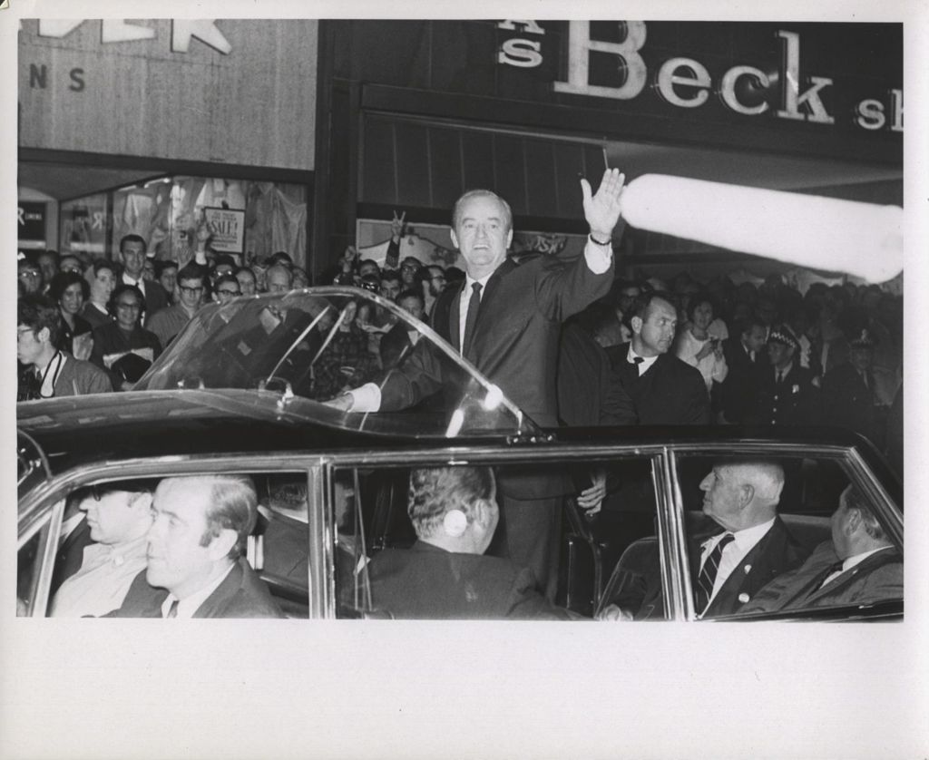 Hubert Humphrey waving to a crowd