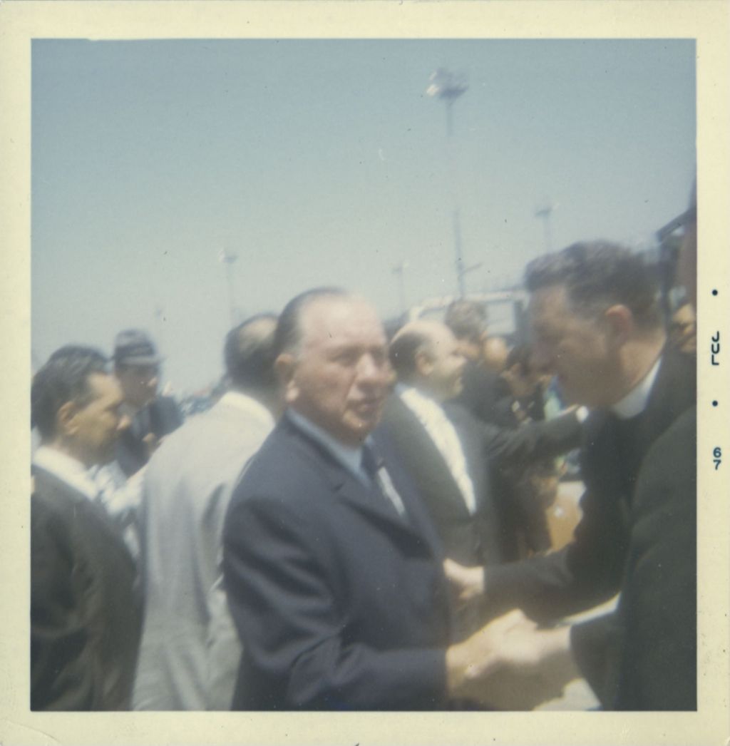 Richard J. Daley greets a priest at Rome airport