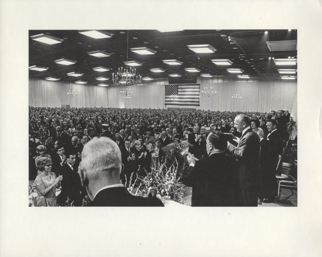 Lyndon B, Johnson applauded by crowd at a banquet