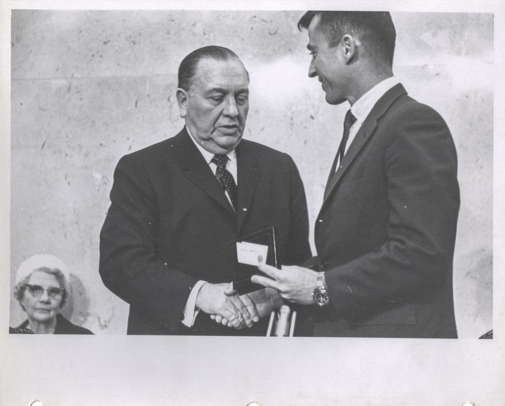 Astronaut Young receiving award from Richard J. Daley