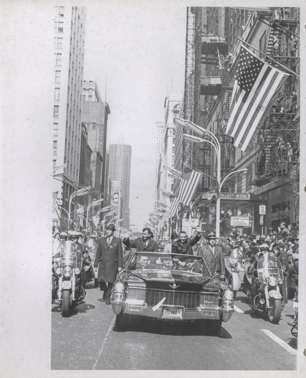 Astronauts Young and Grissom waving to the crowd during a parade