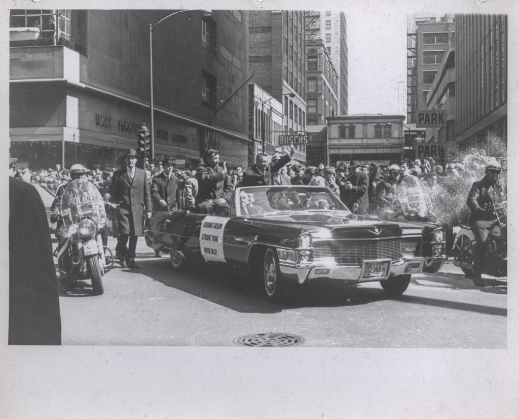 Astronauts Young and Grissom waving to the crowd during a parade