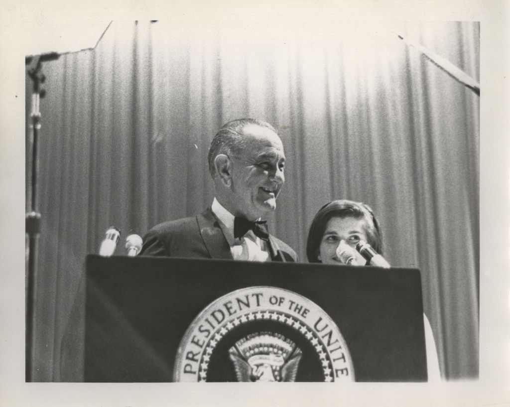 Lyndon B. Johnson and daughter Luci at a podium