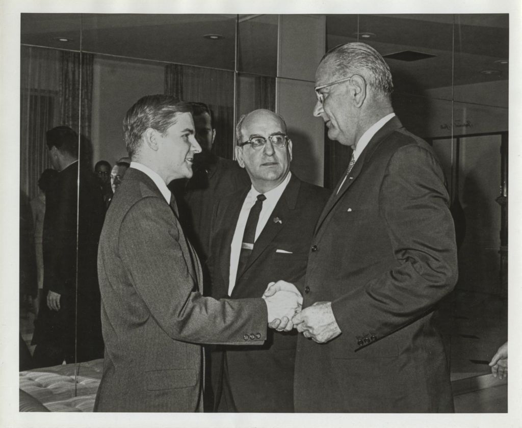 Miniature of Lyndon B. Johnson shaking hands with a young man