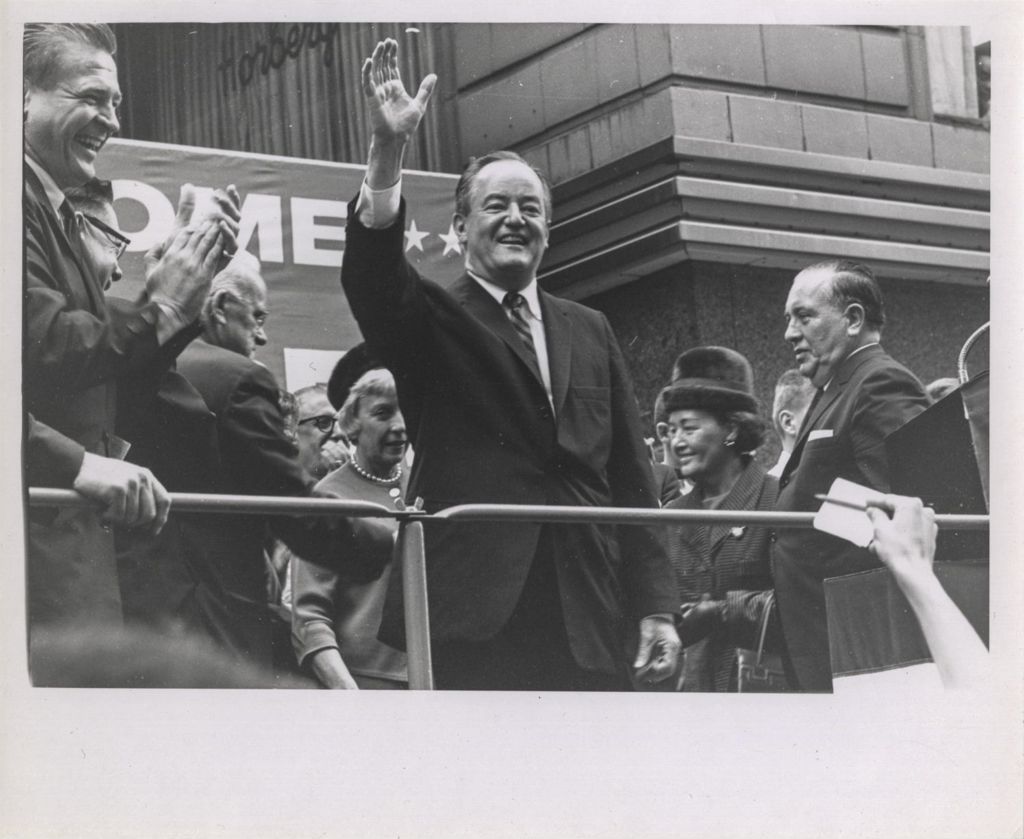 Hubert Humphrey waving to outdoor audience