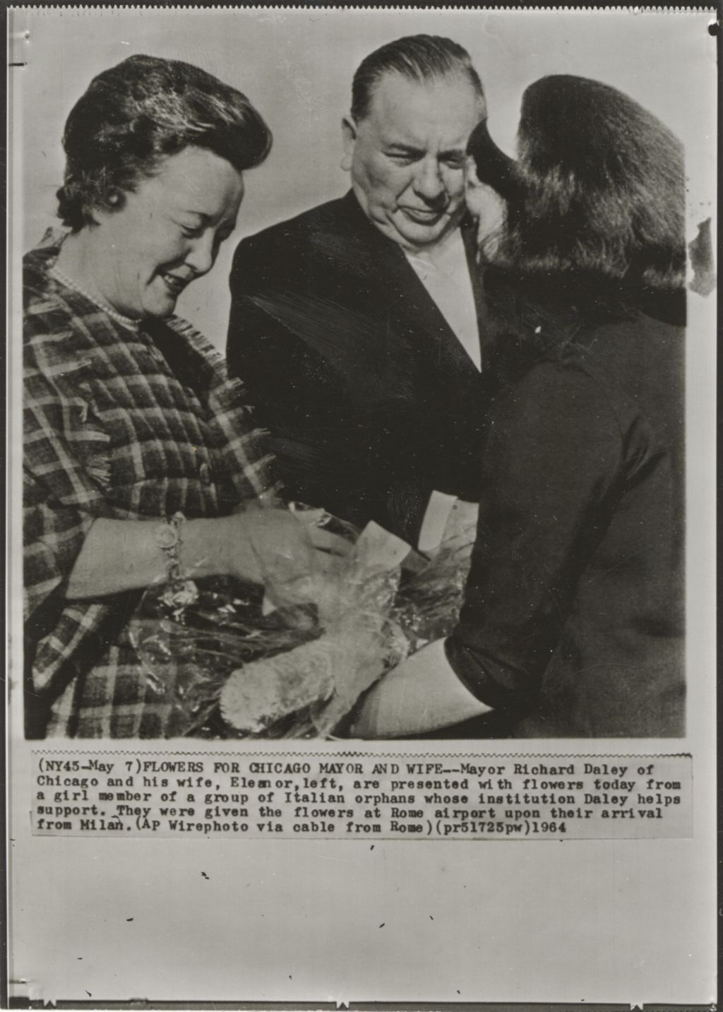 Richard J. Daley and Eleanor Daley receiving flowers at Rome airport