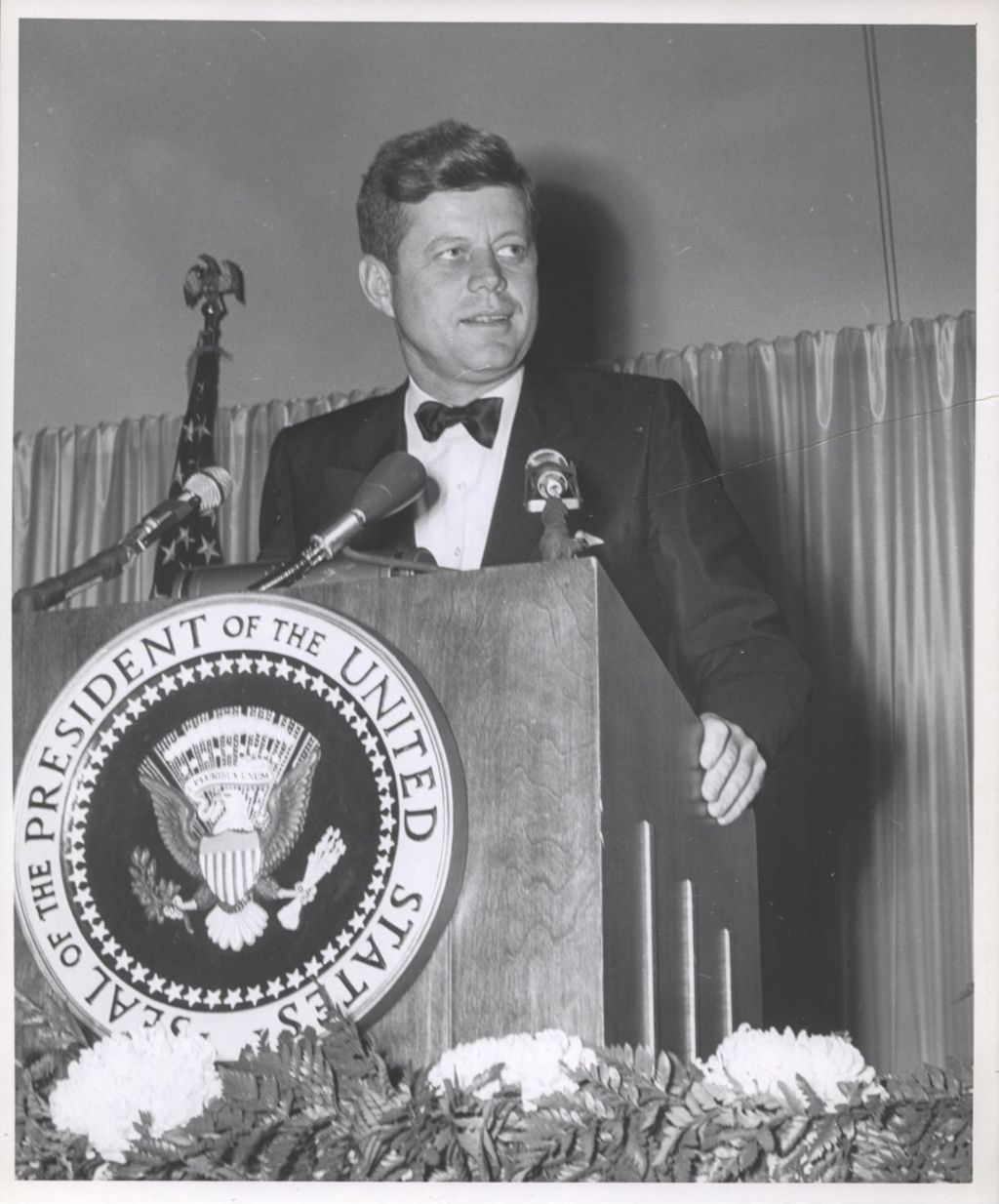 John F. Kennedy at the speaker's podium at Democratic fundraising dinner