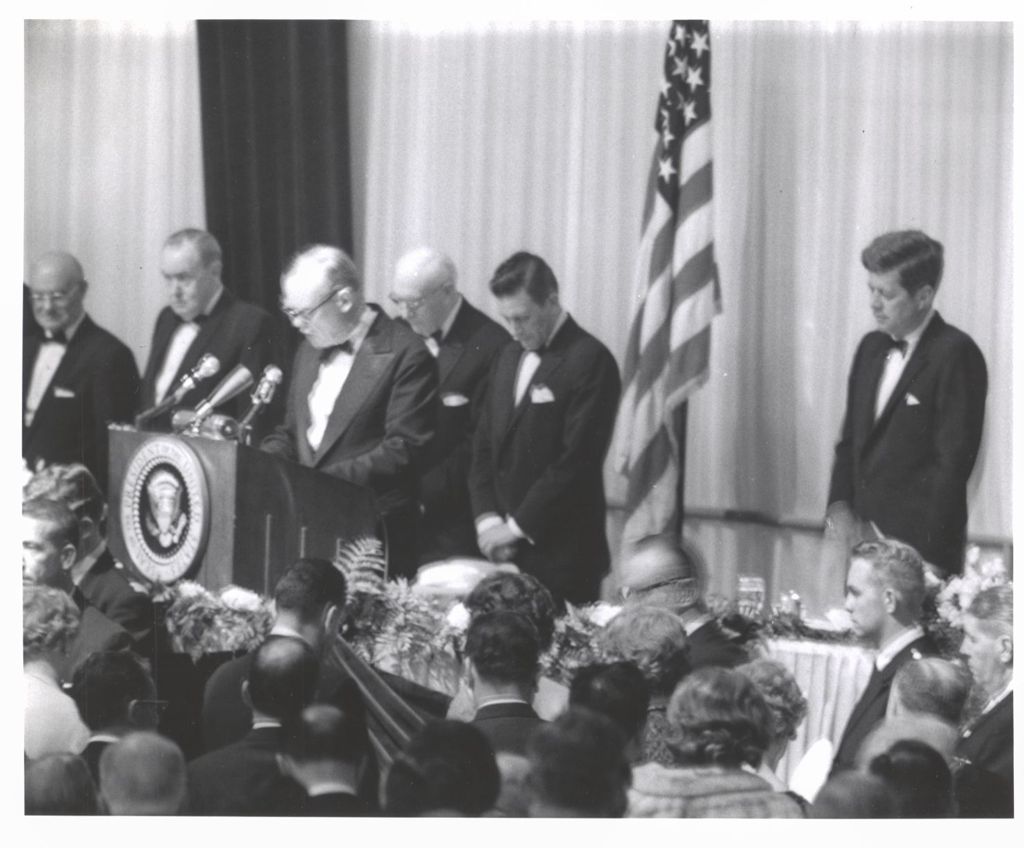 Miniature of John F. Kennedy listens to opening prayer at Democratic fundraising dinner
