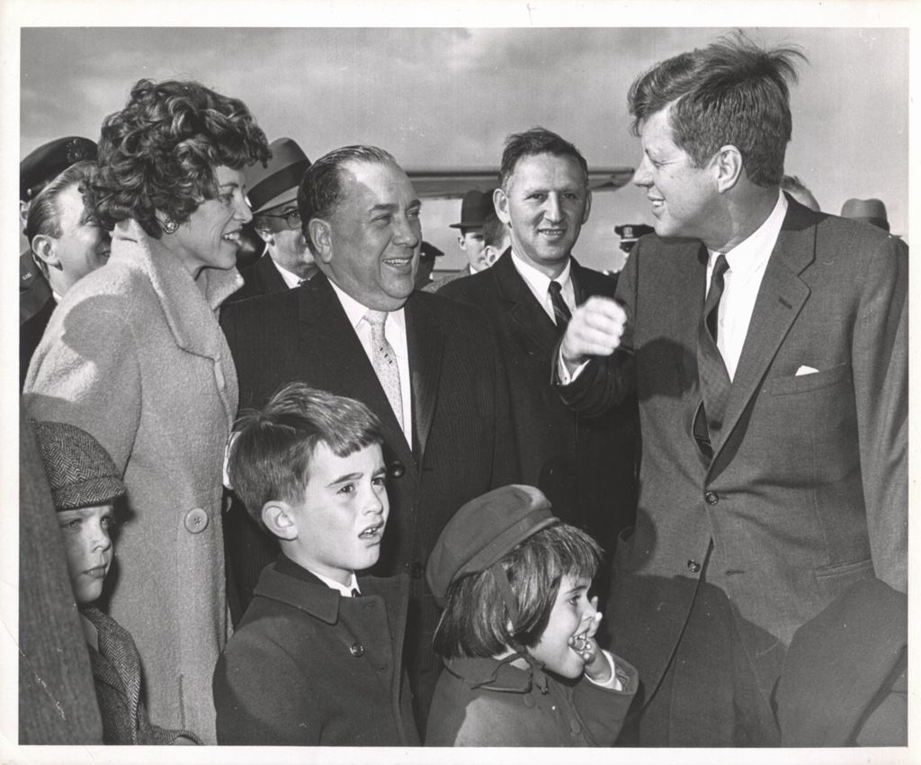 Eunice Kennedy Shriver, Richard J. Daley, John F. Kennedy, and others at the airport