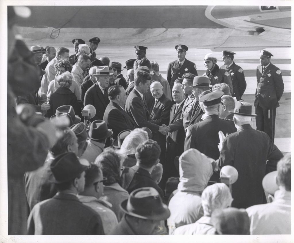 Miniature of President John F. Kennedy shaking hands on the airport tarmac