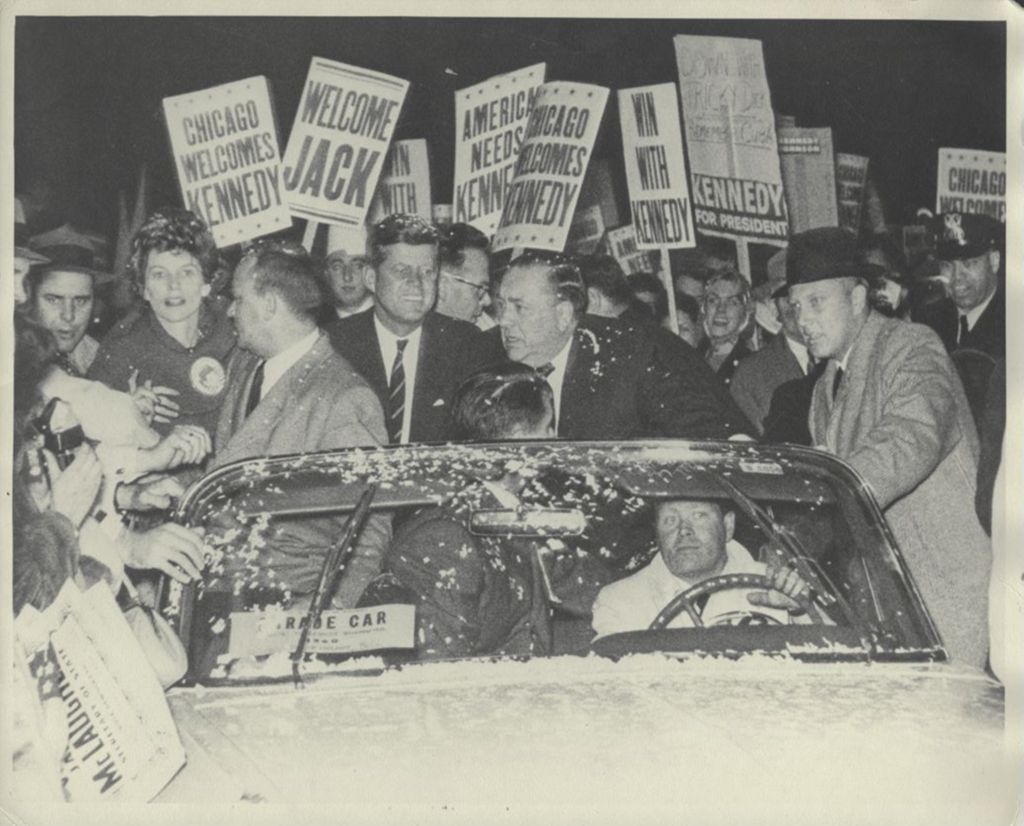 John F. Kennedy and Richard J. Daley riding in a torchlight parade