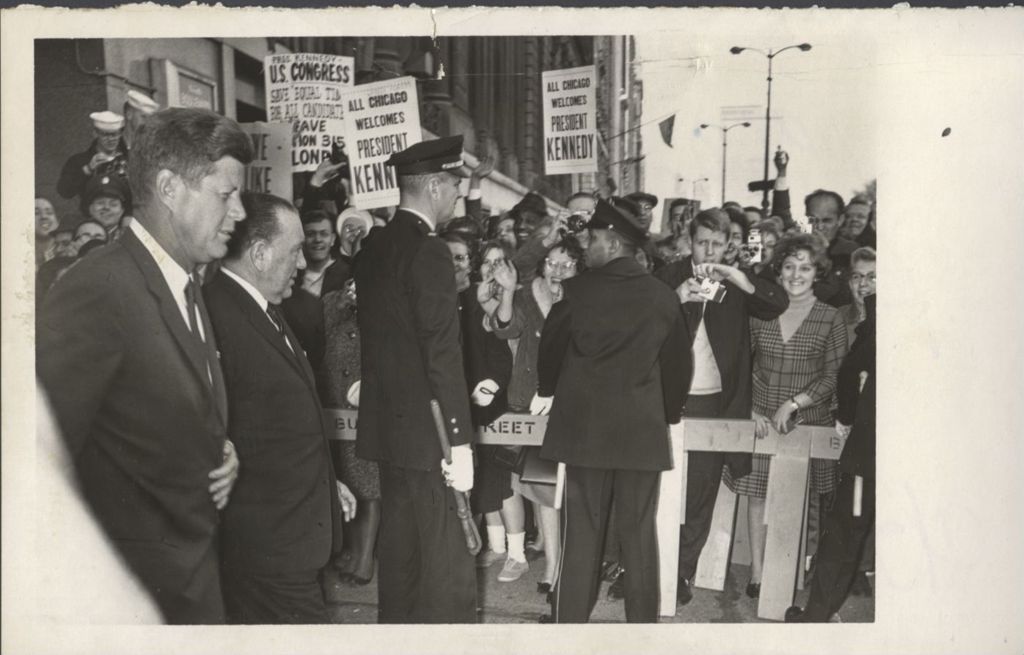 John F. Kennedy and Richard J. Daley walk down a Chicago street