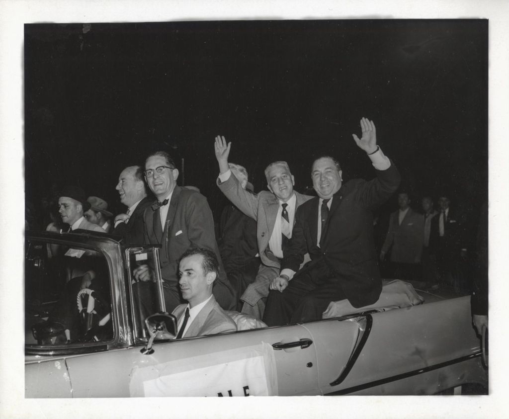 Richard J. Daley, Adlai Stevenson, and others riding in an open top car