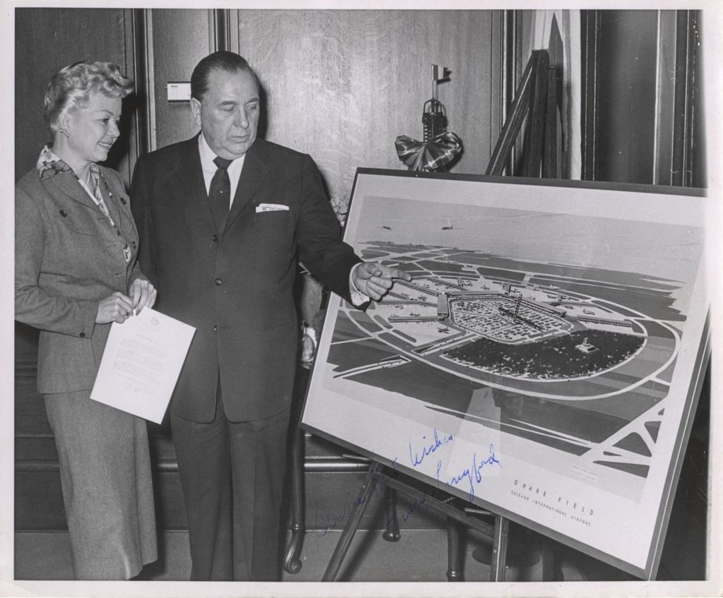 Miniature of Richard J. Daley showing Frances Langford a drawing of O'Hare Field