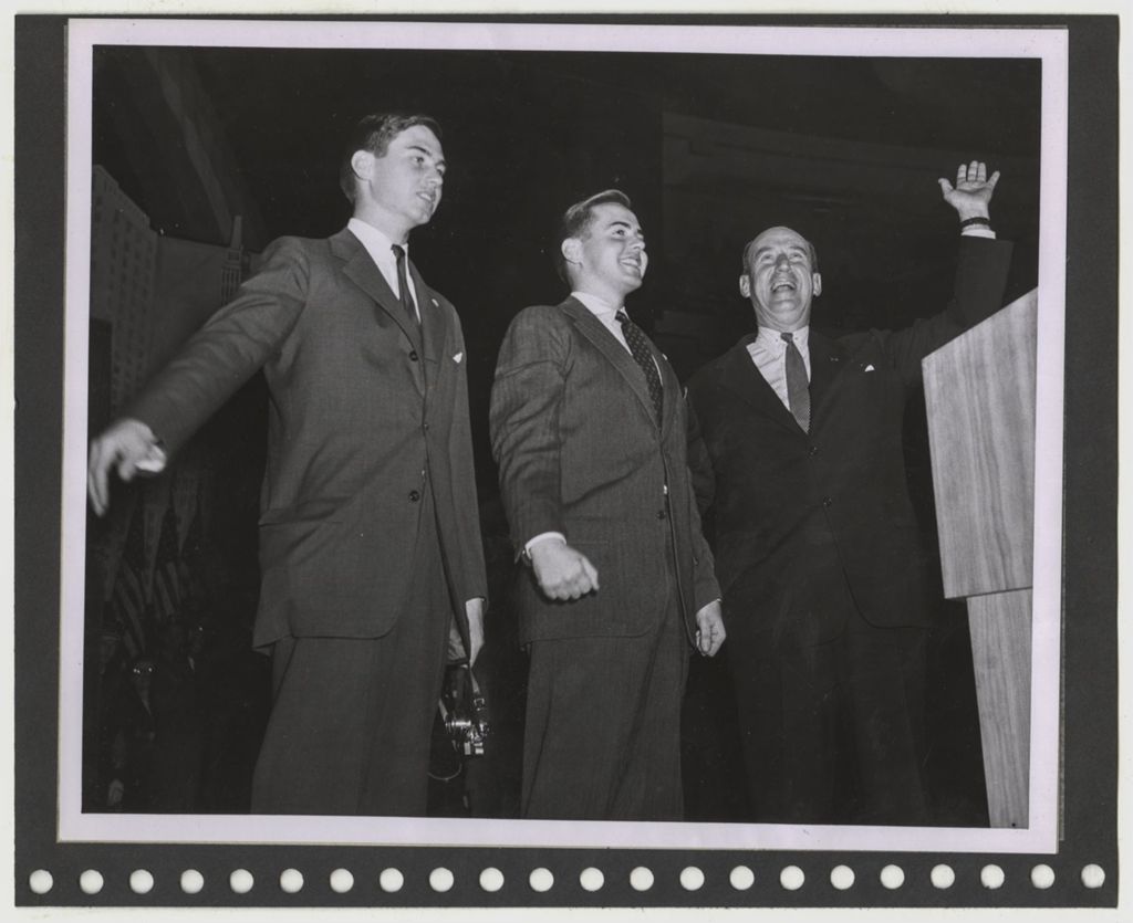 Adlai Stevenson and others standing at a podium