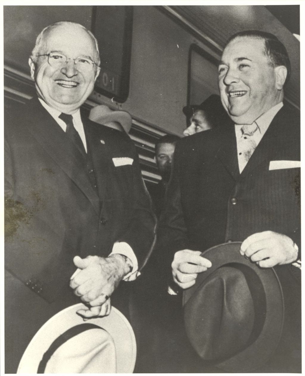 Harry S. Truman and Richard J. Daley standing together, smiling
