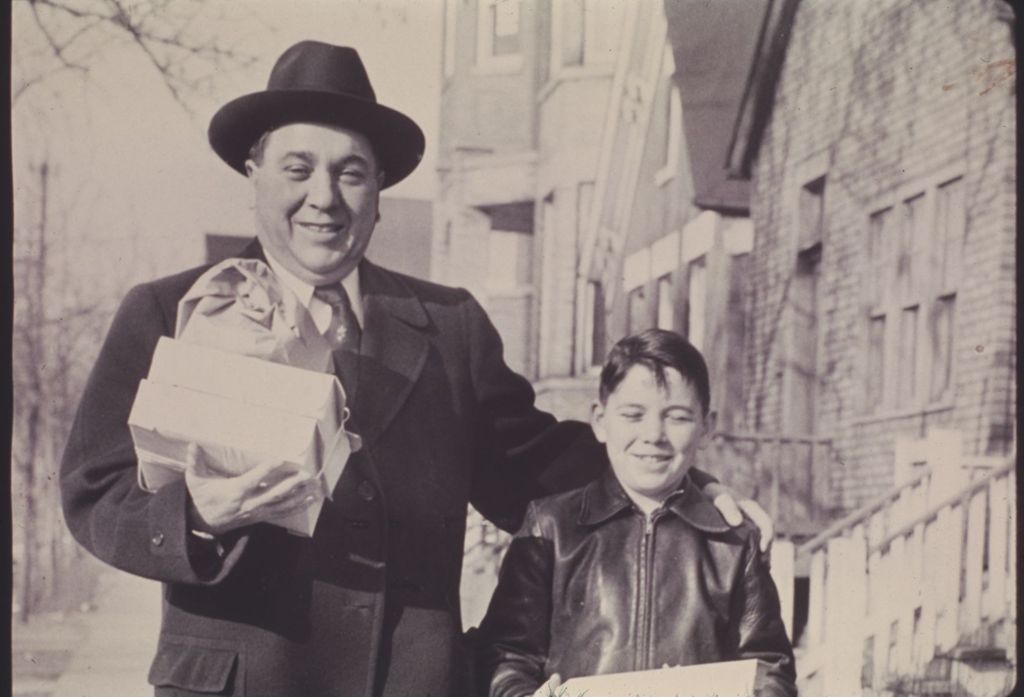 Miniature of Richard J. Daley and Michael Daley carrying packages