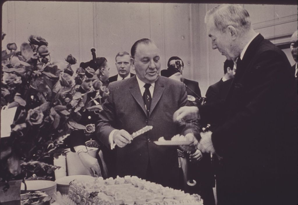 Miniature of Richard J. Daley serves cake at an anniversary celebration
