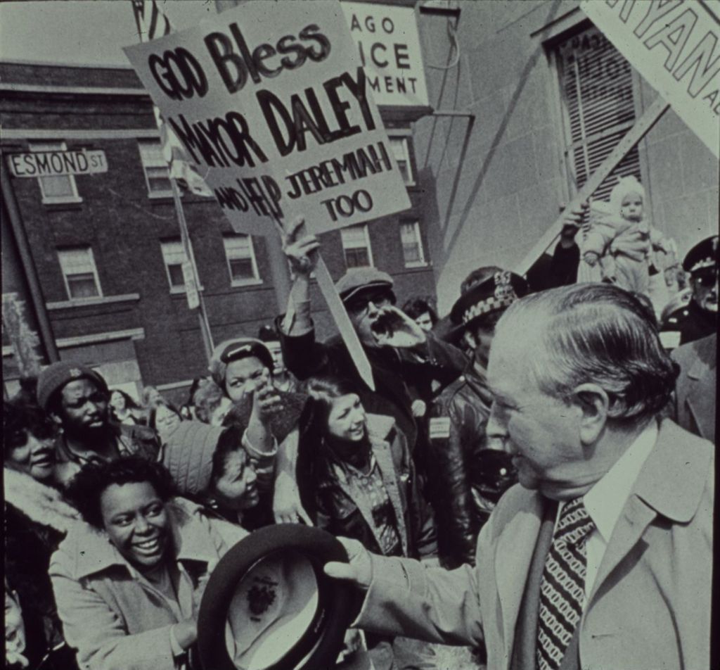 Richard J. Daley with supporters carrying signs