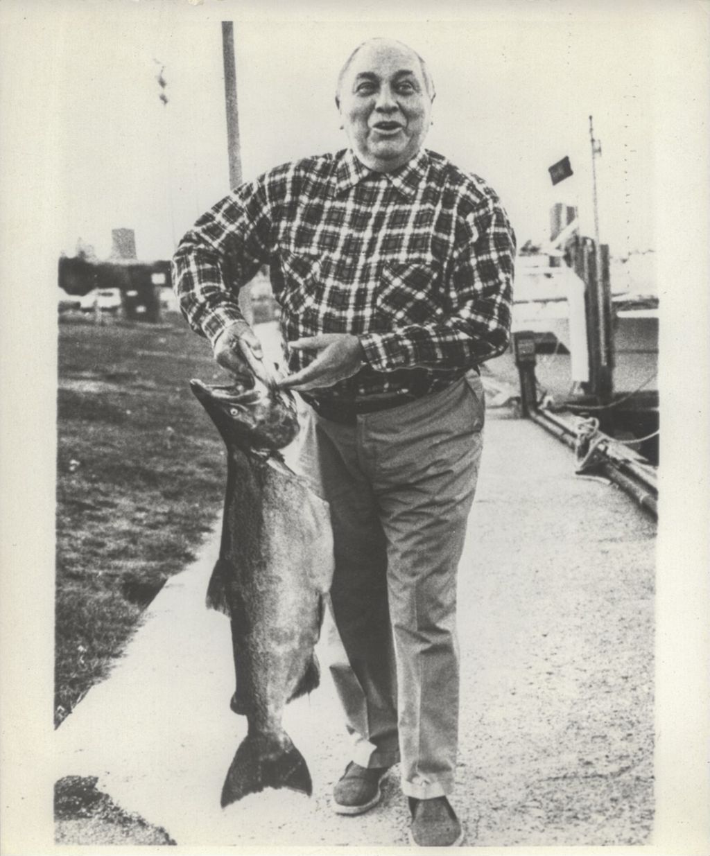 Richard J. Daley displaying a coho salmon