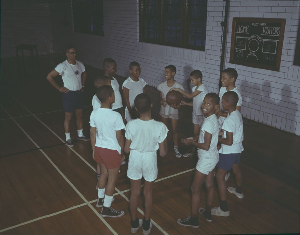Boys playing basketball in a gymnasium
