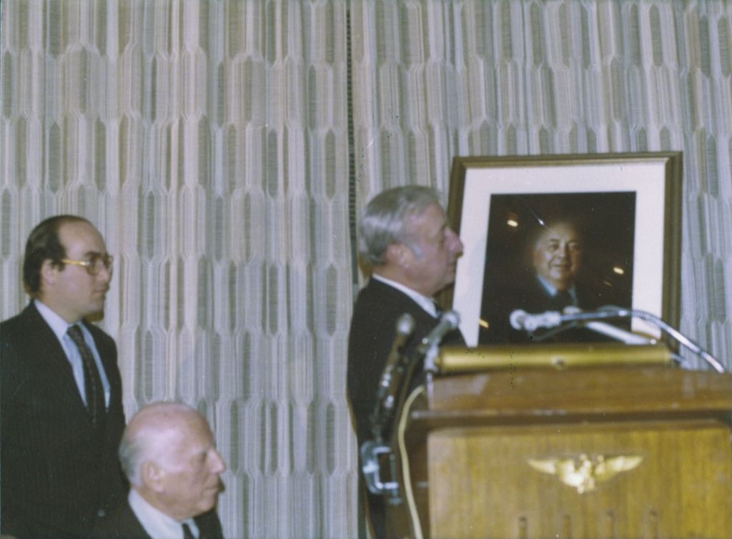 Man holding a portrait of Richard J. Daley at a Daley portrait event