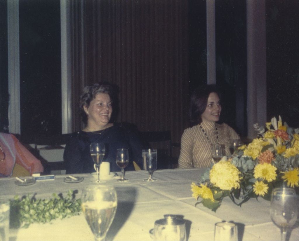Eleanor R. Daley and a young woman at a banquet table