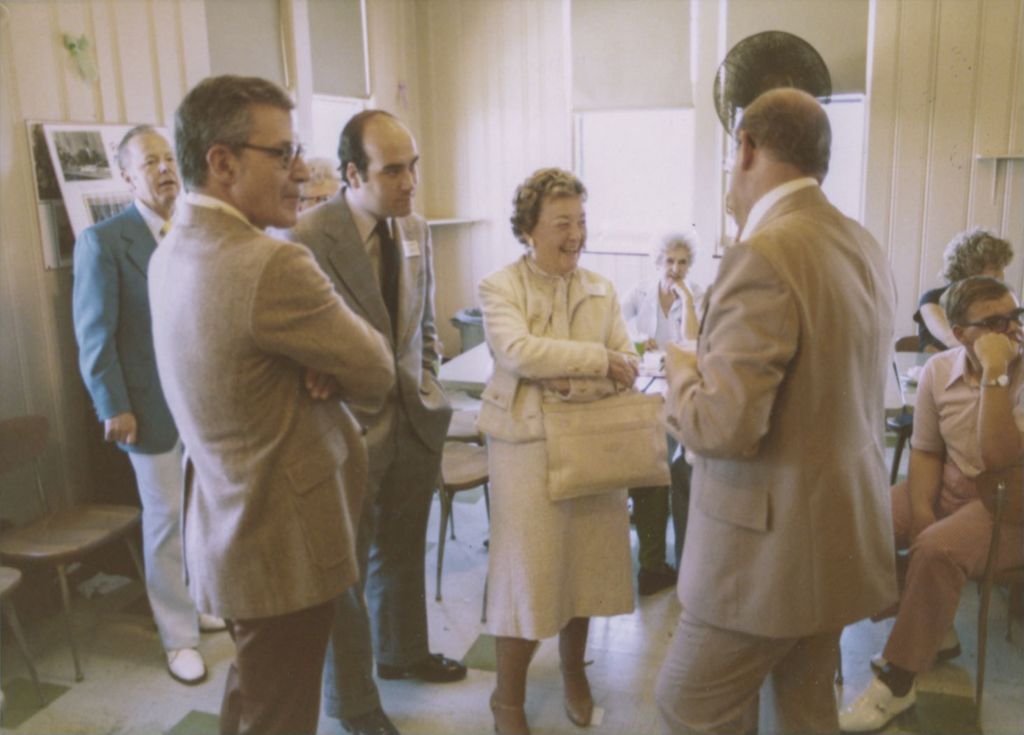 Eleanor and William Daley in conversation with others