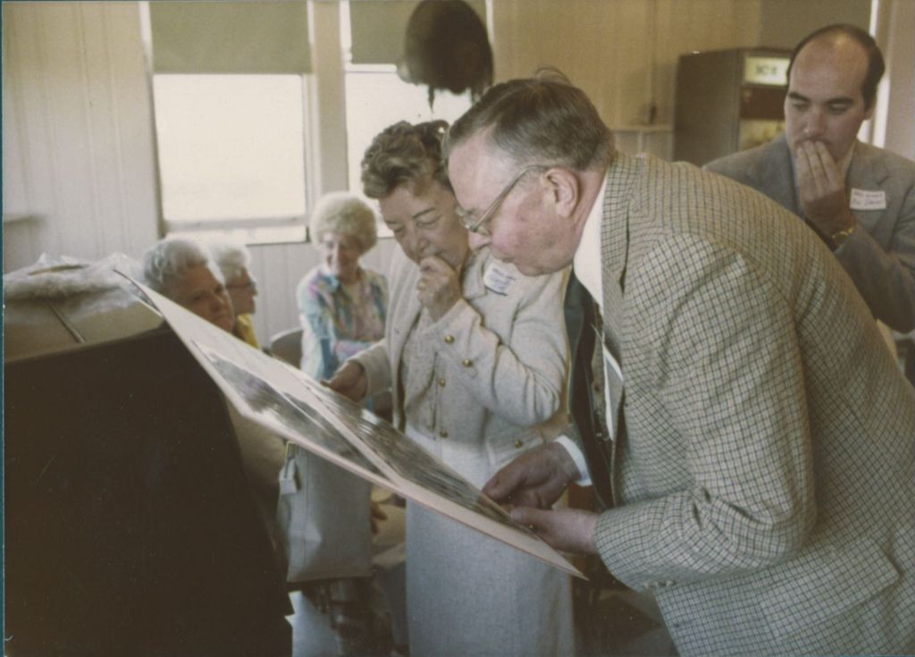 Miniature of Eleanor Daley and a man examining a poster board