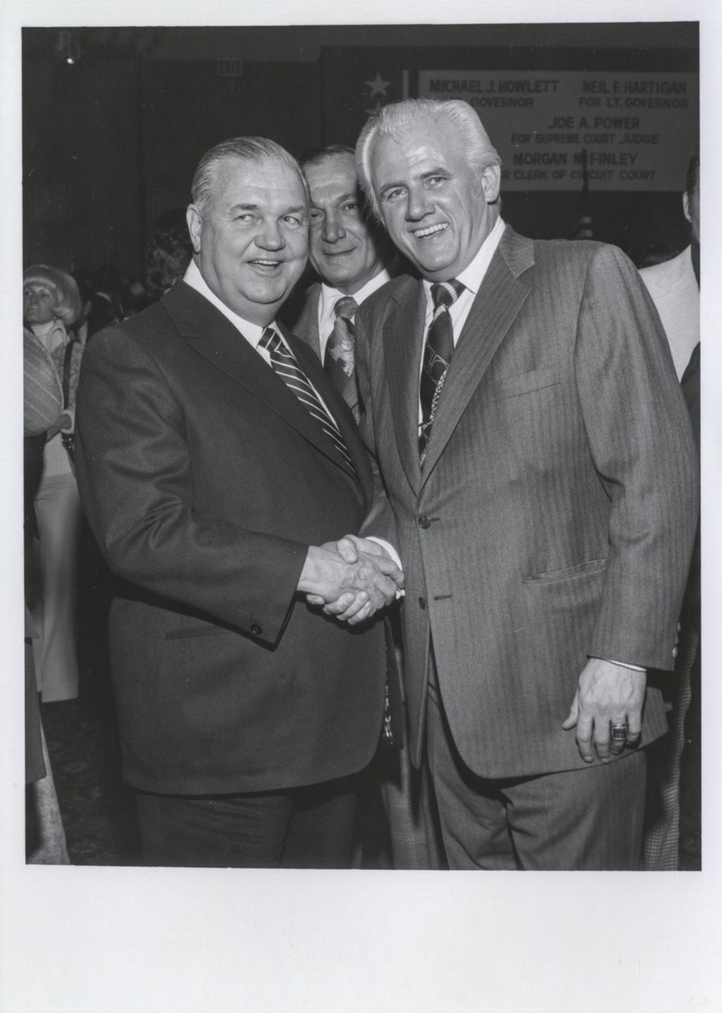 Miniature of Michael J. Howlett shaking hands with an man at a Democratic Club of Winnetka event
