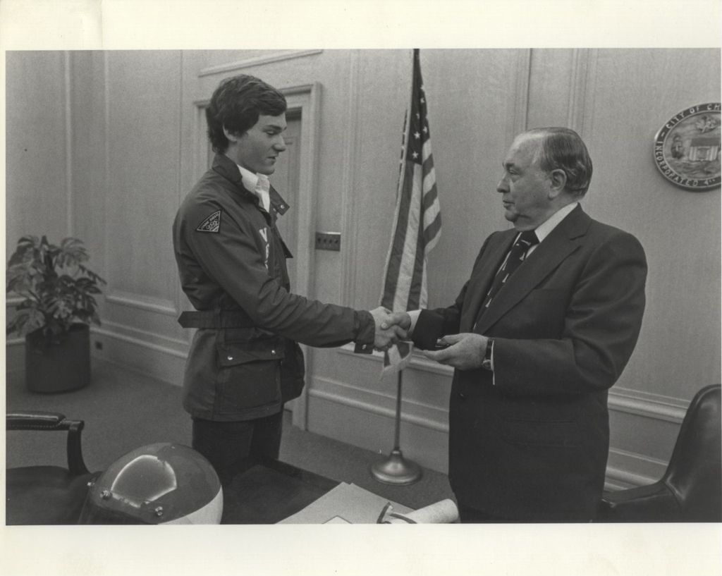 Richard J. Daley shaking hands with an Olympic athlete