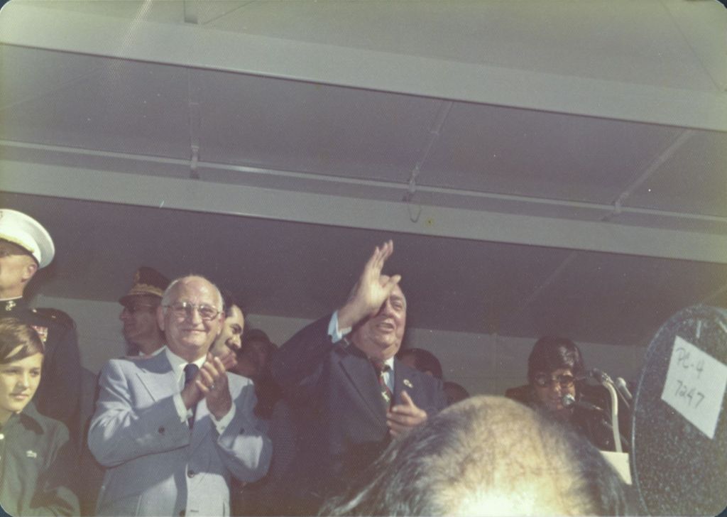Richard J. Daley waving from a parade reviewing stand