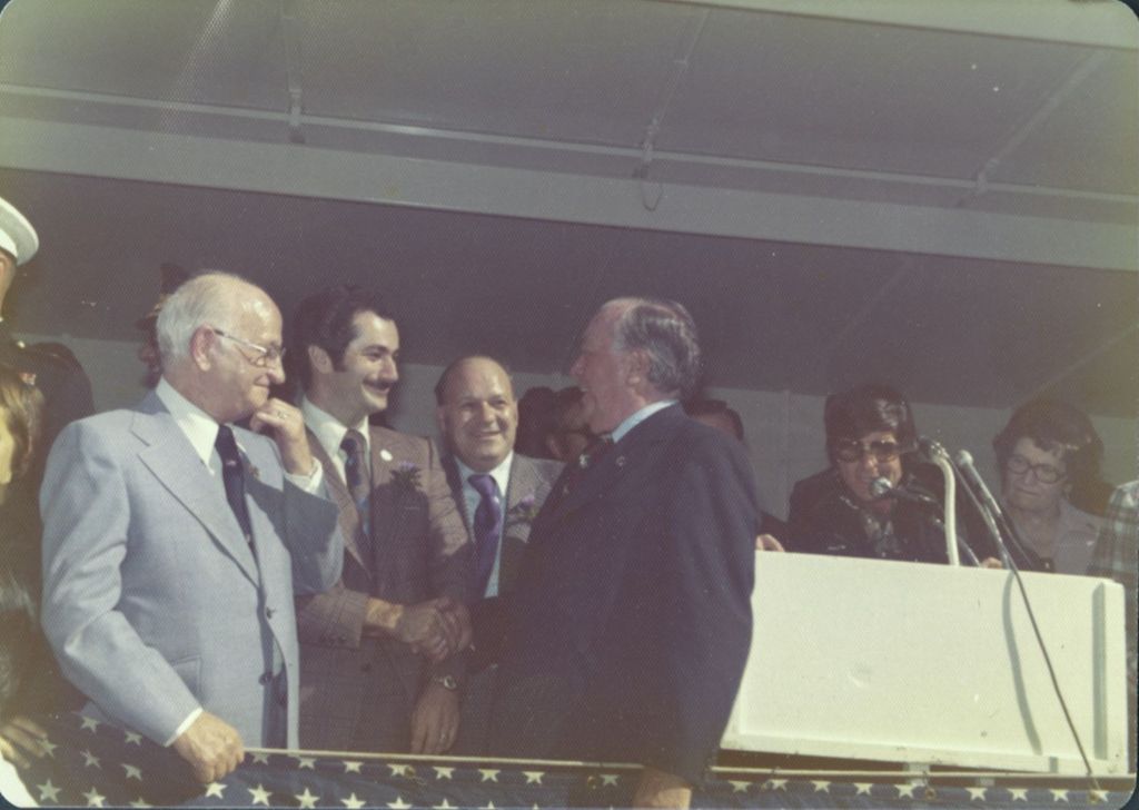 Miniature of Richard J. Daley shaking hands on parade reviewing stand
