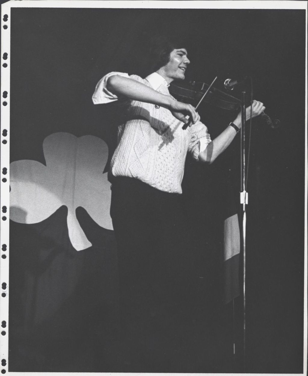 Fiddler playing at a microphone