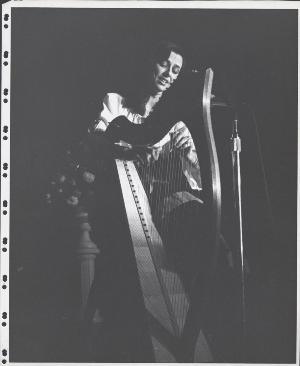 Harpist playing behind a microphone