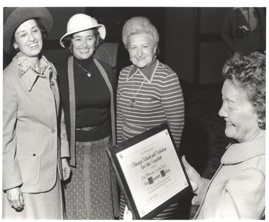 Miniature of Eleanor Daley receives Woman of the Year plaque