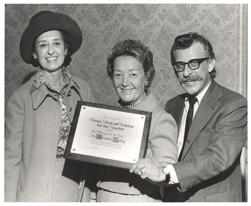 Miniature of Eleanor Daley receives Woman of the Year plaque