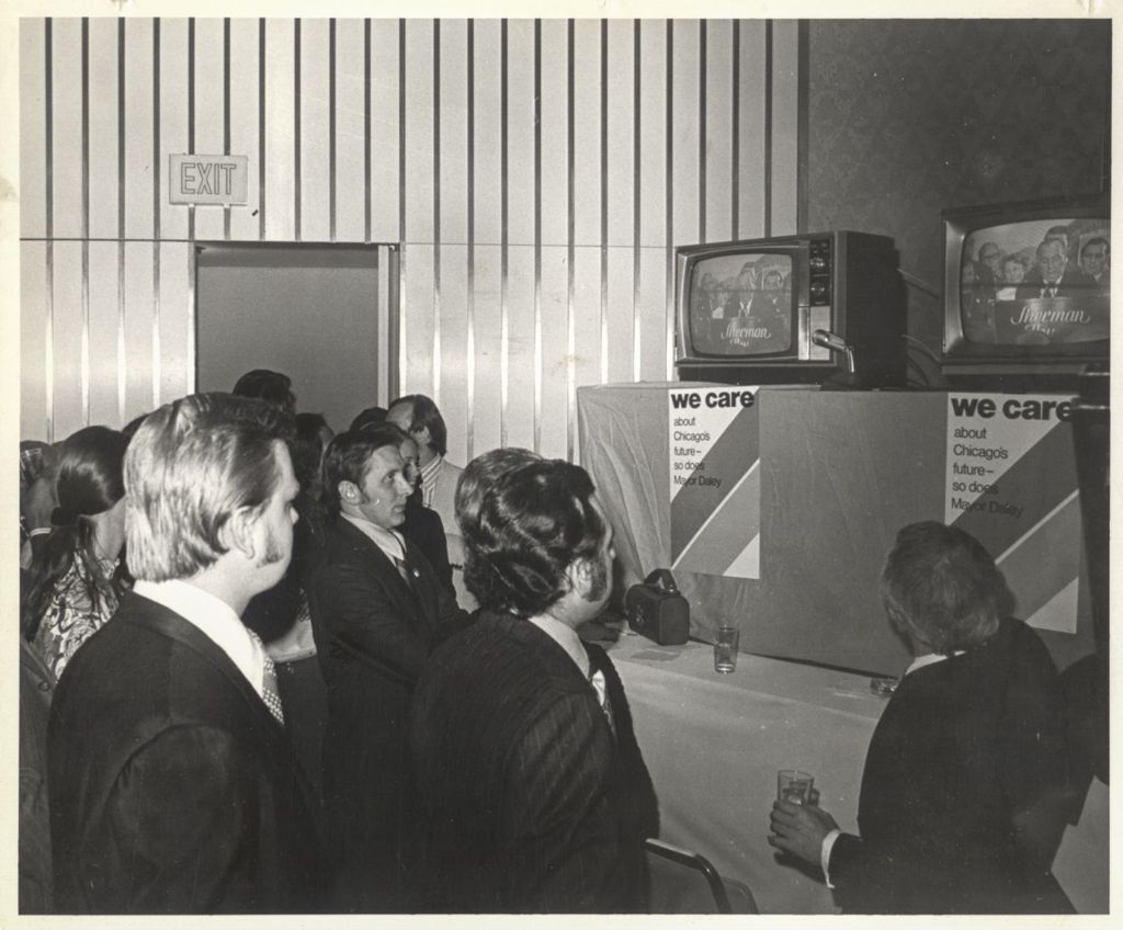 Watching election results on television at a "We Care" election event