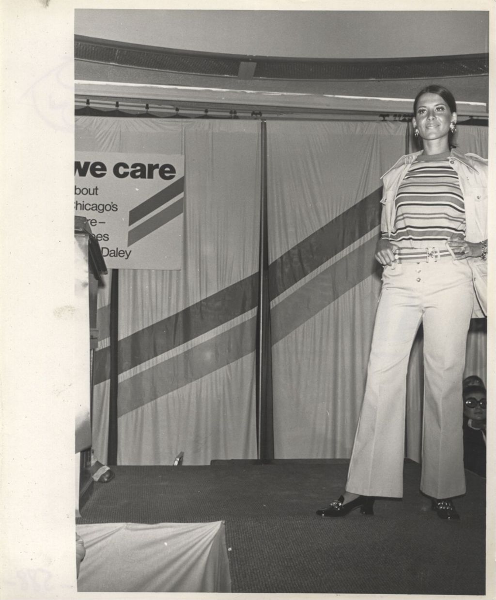 Woman modeling an outfit at a "We Care" event