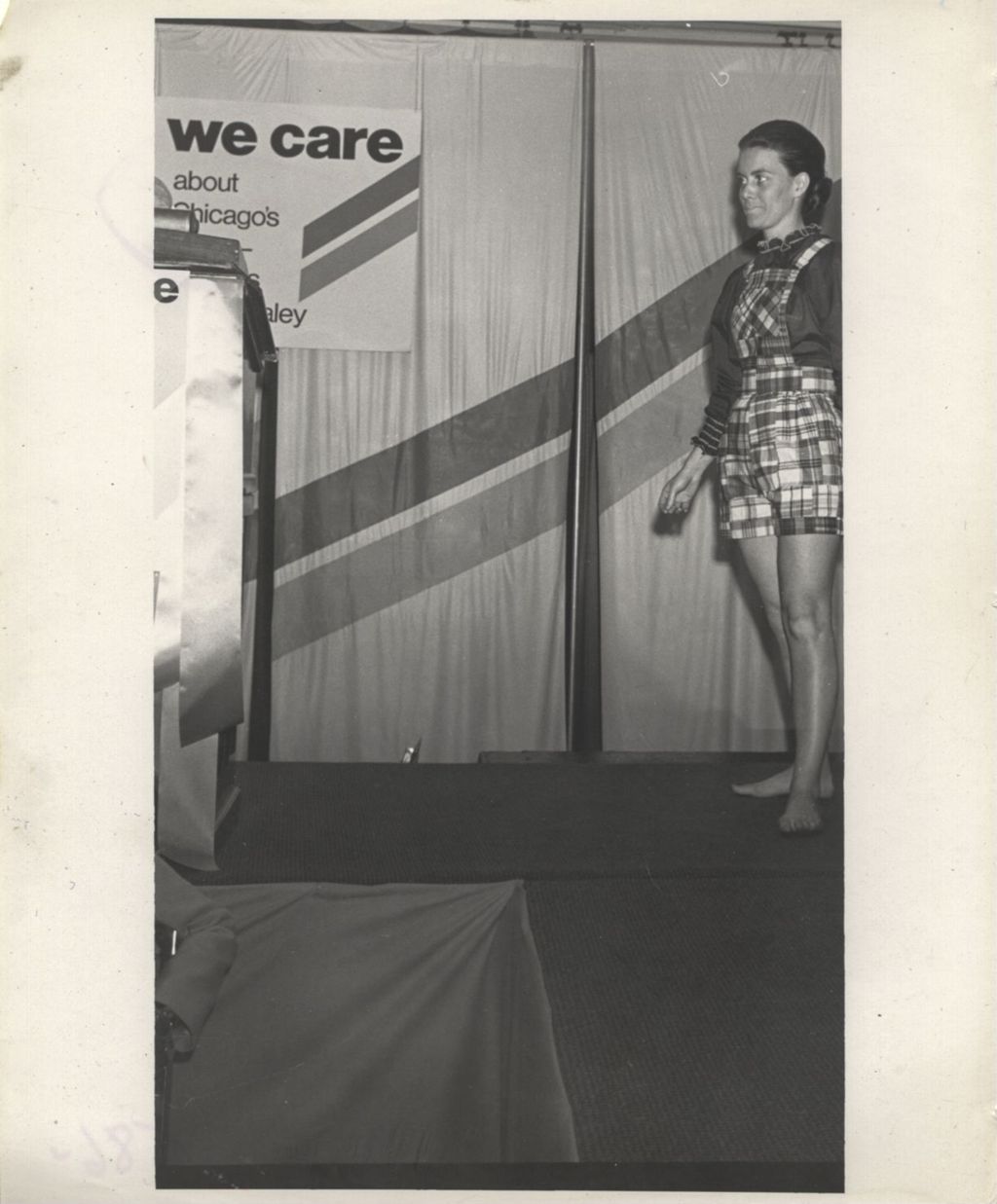 Woman modeling an outfit at a "We Care" event