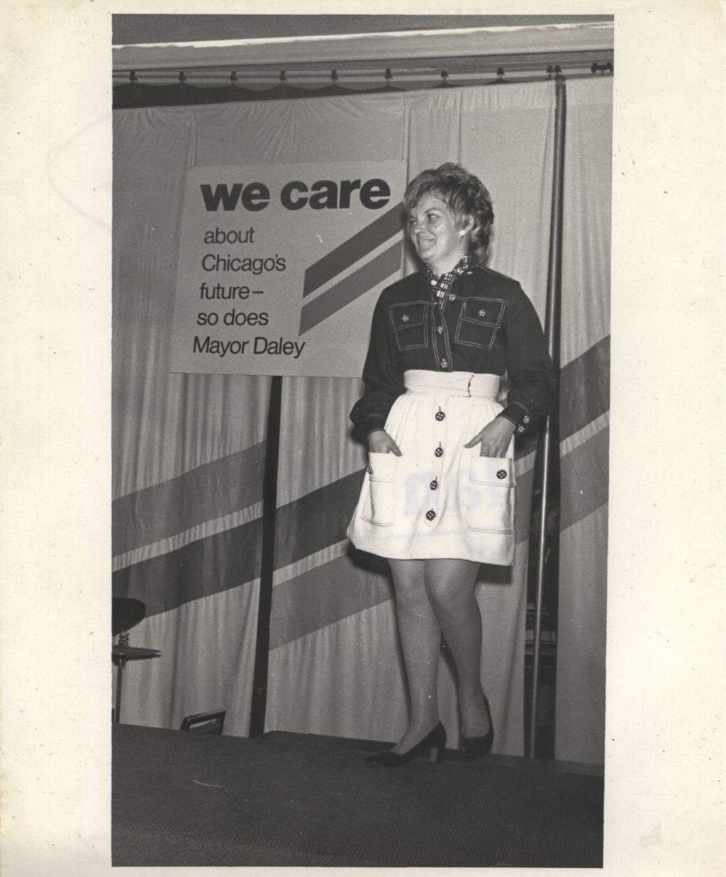 Miniature of Eleanor R. Daley modeling an outfit at a "We Care" event