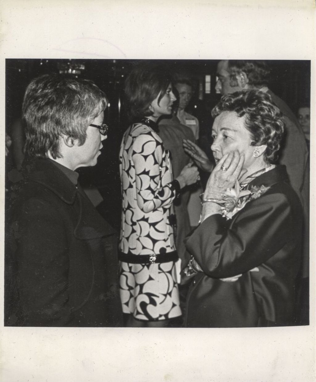 Miniature of Eleanor Daley talking with a woman at a "We Care" campaign luncheon