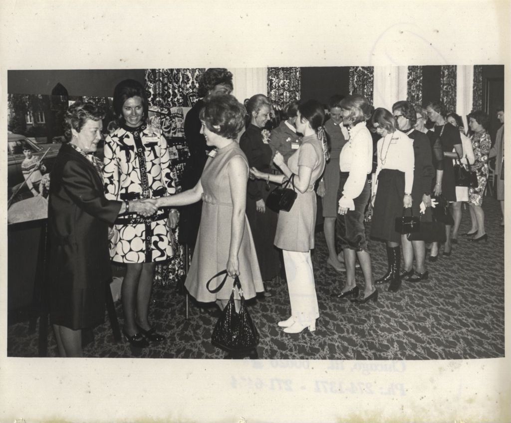 Eleanor Daley shaking hands in a receiving line at a "We Care" event