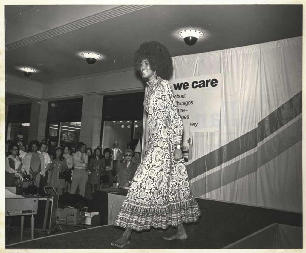 Woman modeling a paisley dress at a "We Care" event