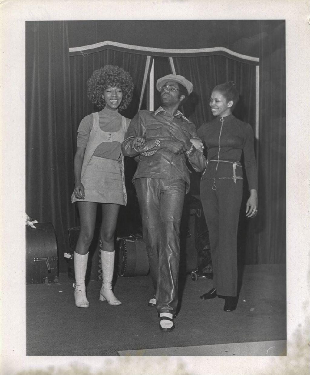 Three people modeling fashions at a "We Care" event