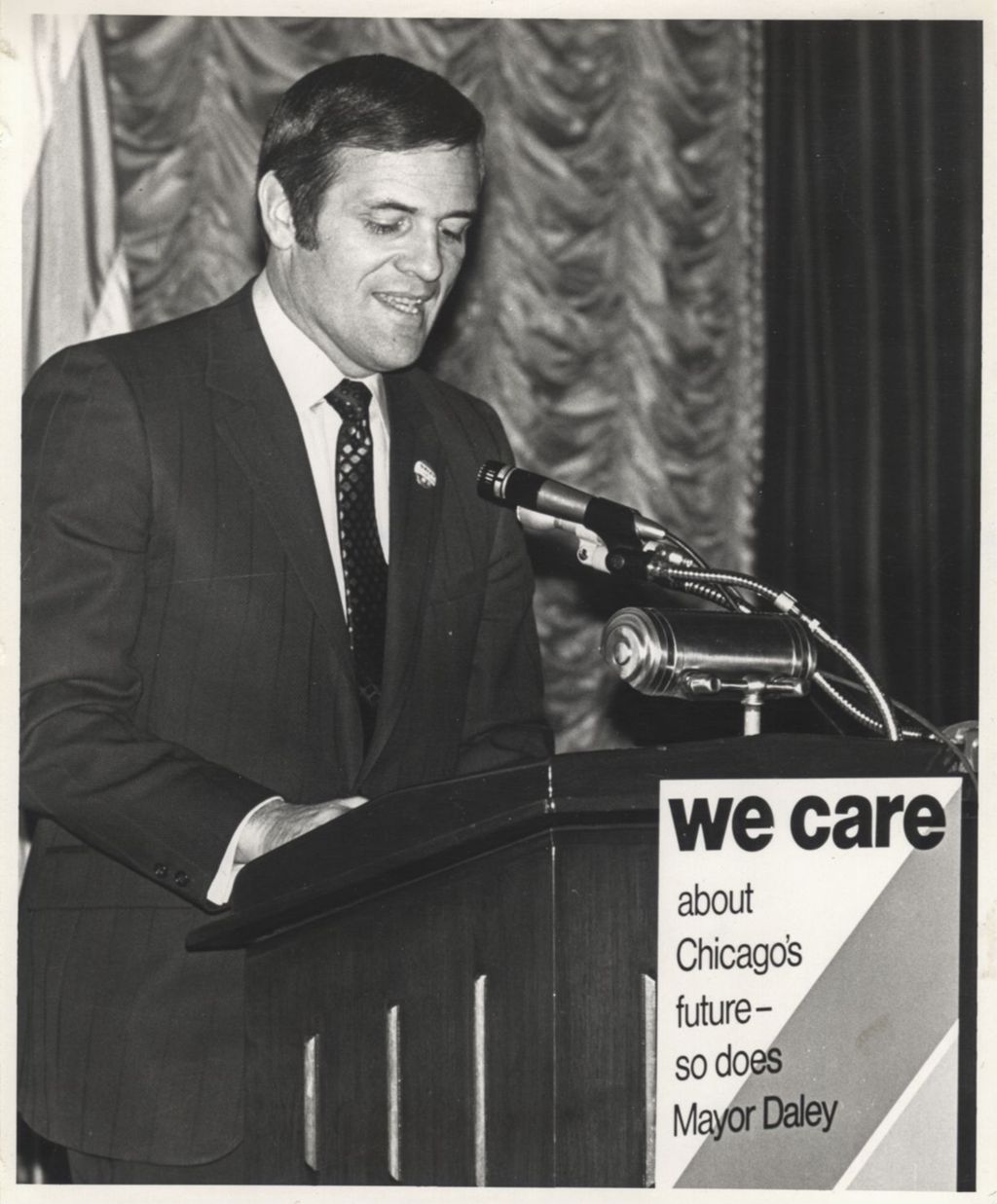Man speaking at a "We Care" event