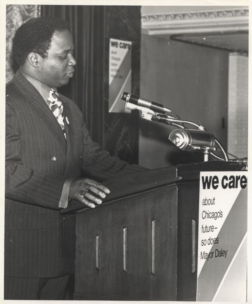 Man speaking at a "We Care" campaign event