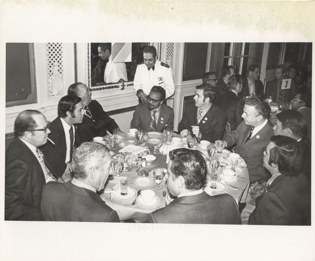 Miniature of Richard J. Daley at a banquet table with others at a "We Care" event