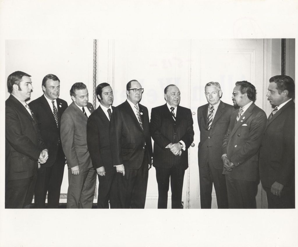 Richard J. Daley standing with a group of men at a "We Care" event